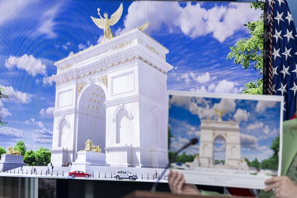 epa12892266 White House Press Secretary Karoline Leavitt holds up an illustration of the Triumphal Arch that President Trump is submitting plans to build during a press briefing at the White House in  ...