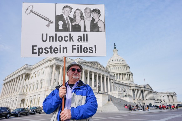 Gary Rush, College Park, MD, holds a sign before a news conference on the Epstein files in front of the Capitol, Tuesday, Nov. 18, 2025, in Washington. (AP Photo/Mariam Zuhaib)
House Epstein