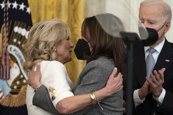 First lady Jill Biden, left, embraces Vice President Kamala Harris, with President Joe Biden, right, during a &quot;Cancer Moonshot,&quot; event in the East Room of the White House, Wednesday, Feb. 2, ...