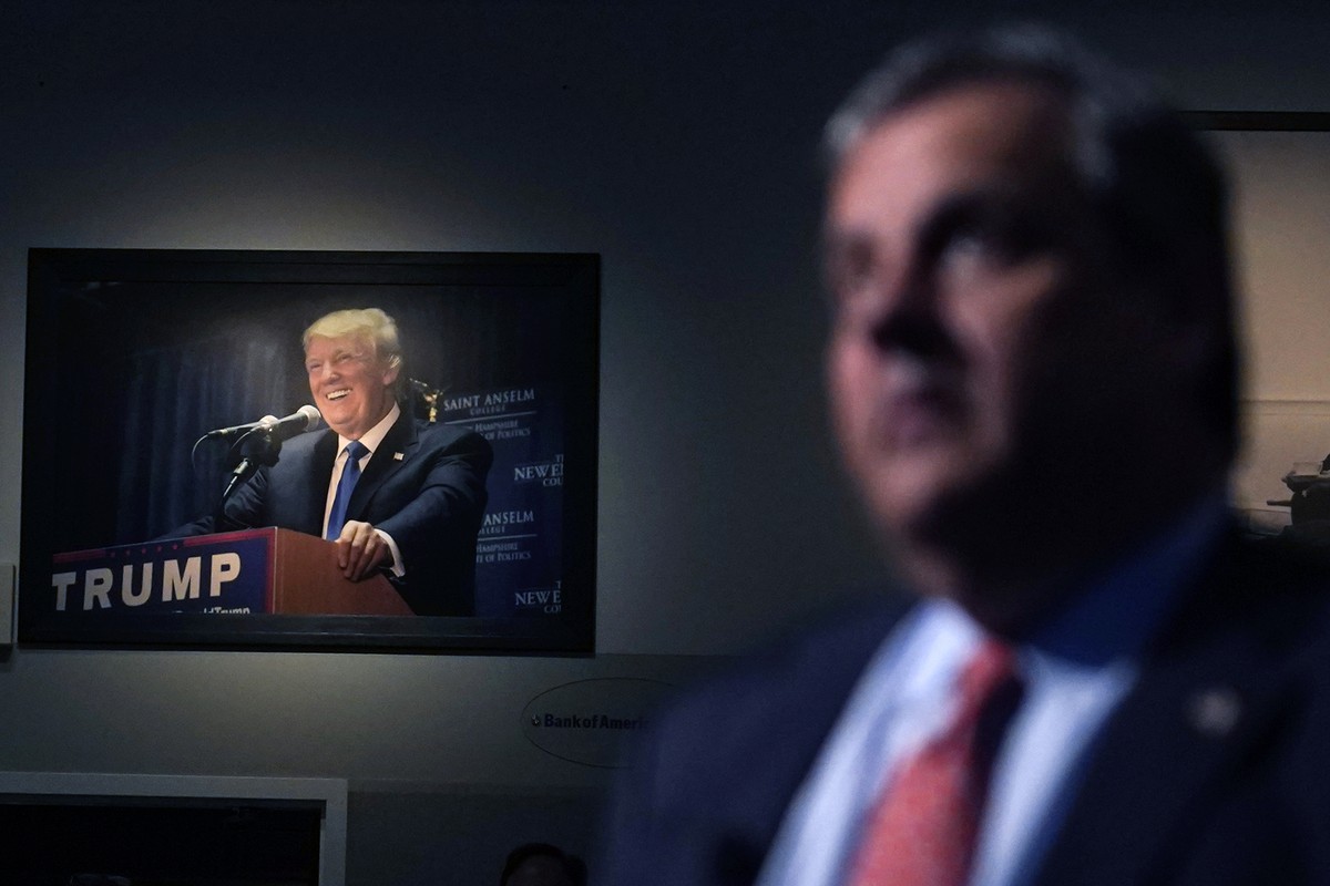 A photograph of former President Trump hangs on the wall as Republican Presidential candidate former, New Jersey Gov. Chris Christie listens to a question during a gathering, Tuesday, June 6, 2023, in ...