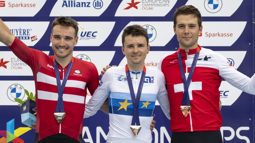 From left, Denmark's second placed Sebastian Fini Carstensen, Great Britain's gold medallist Thomas Pidcock and Switzerland's third placed Filippo Colombo after the Mountainbike Men's Cross Country Co ...