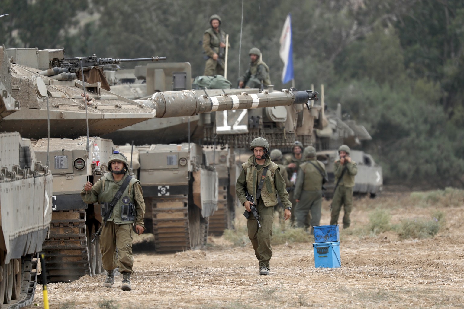 epa10909242 Israeli soldiers and military vehicles gather at an area along the border with Gaza, southern Israel, 09 October 2023. The Israeli army announced on 09 October, it carried out over 500 str ...