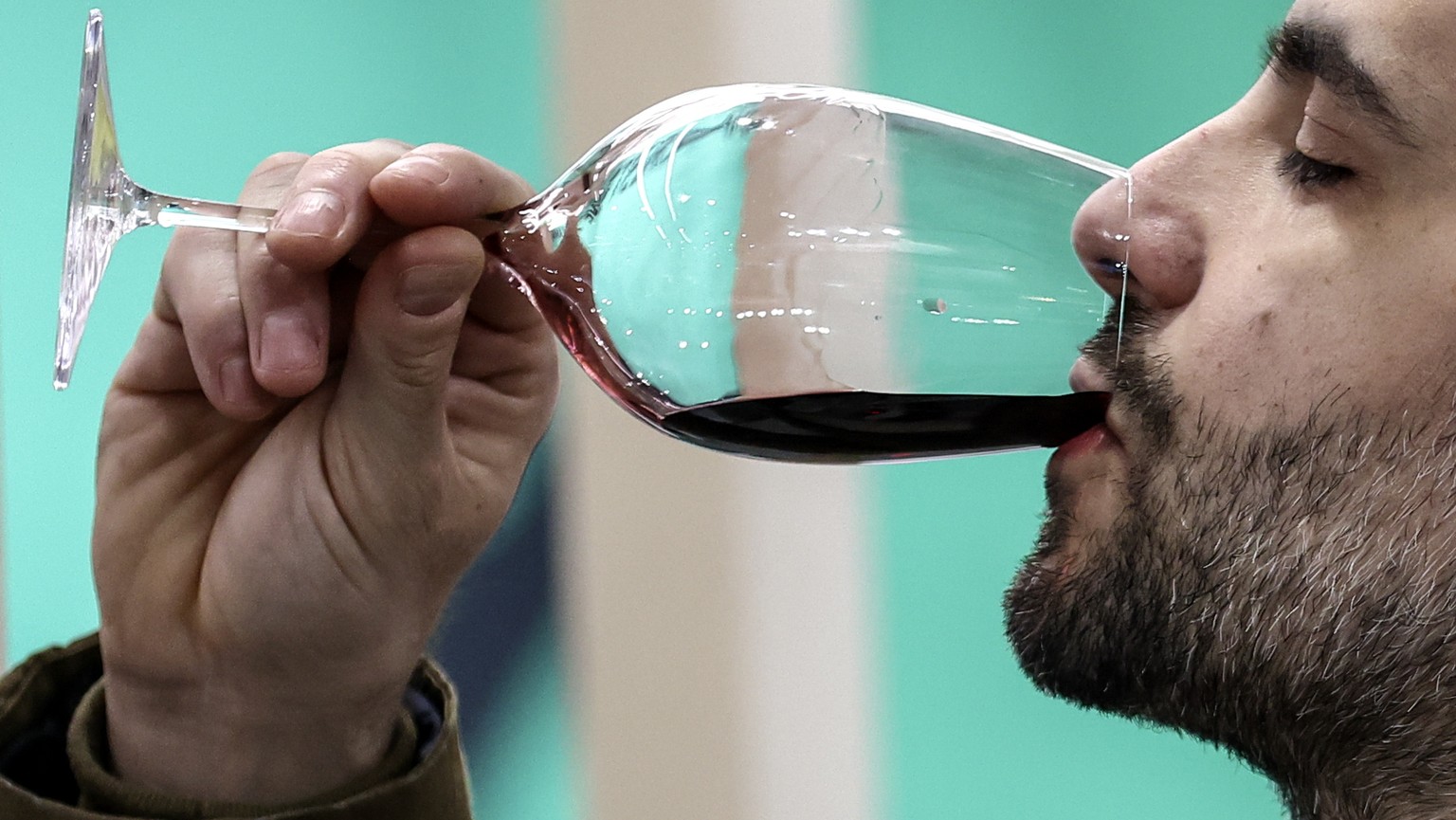 epa11150562 A visitor tastes a wine sample at the Vinexpo wine fair at the Paris Expo Porte de Versailles exhibition center in Paris, France, 13 February 2024. The Vinexpo Paris 2024 wine fair, gather ...