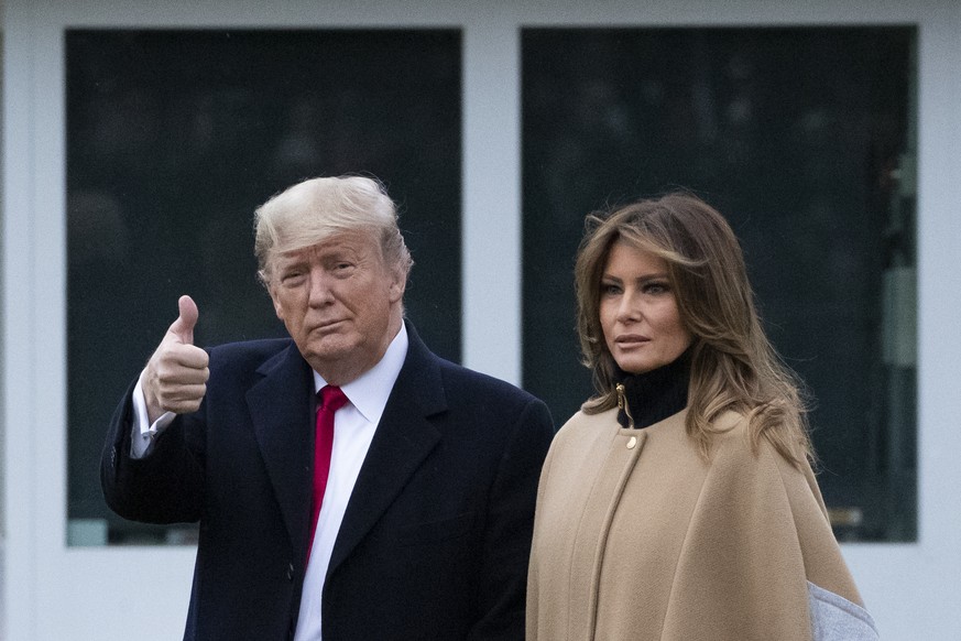 President Donald Trump, accompanied by first lady Melania Trump, gives thumbs up as he walks on the South Lawn as they depart the White House, Friday, Jan. 31, 2020, in Washington. Trump is en route t ...