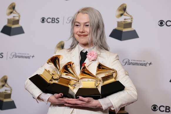 epa11128278 US singer-songwriter Phoebe Bridgers, holds up Grammy Awards for Best Alternative Music Album for &quot;The Record&quot;, Best Rock Song for &quot;Not Strong Enough&quot;, Best Rock Perfor ...