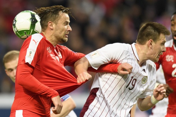 Swiss forward Haris Seferovic, left, fights for the ball with Latvia&#039;s defender Vitalijs Jagodinskis, right, during the 2018 Fifa World Cup Russia group B qualification soccer match between Switz ...