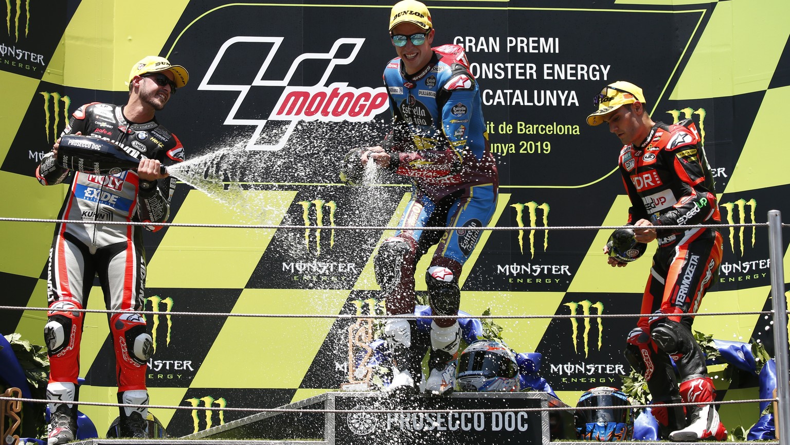 Moto2 race winner Alex Marquez of Spain, center, celebrates with 2nd placed Thomas Luthi of Switzerland, left and 3rd placed Jorge Navarro of Spain during the Catalunya Motorcycle Grand Prix at the Ba ...