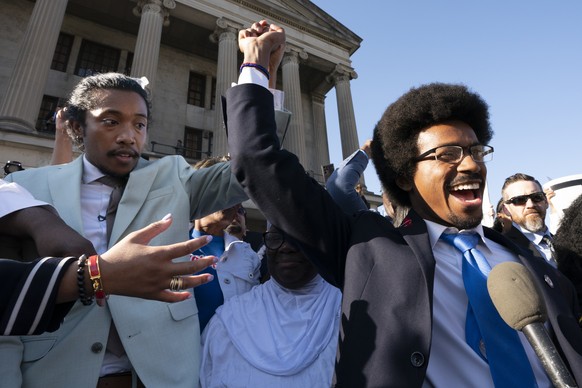 State Representative Justin Jones, D-Nashville, and ousted Representative Justin Pearson, D-Memphis, raise their hands just before Jones takes the oath of office outside the Capitol on Monday, April 10, 2023, in Nas…