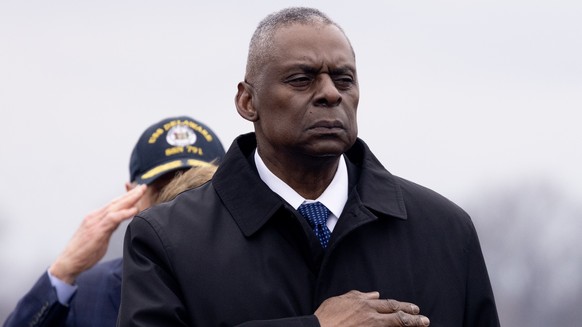 epa11121831 US Secretary of Defense Lloyd Austin watches a US Army transport team move a flag-draped transfer case containing the remains of a fallen US soldier during a dignified transfer in Dover...