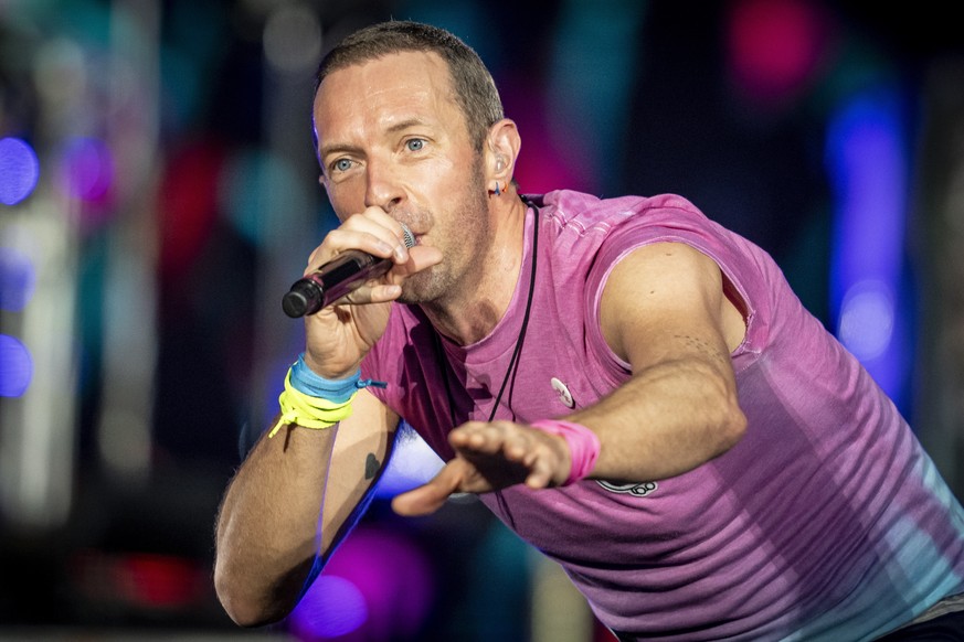 epa10728899 British singer Chris Martin of British band Coldplay performs at Parken Stadium in Copenhagen, Denmark, 05 July 2023. The concert is part of the Music of the Spheres World Tour. EPA/Mads C ...