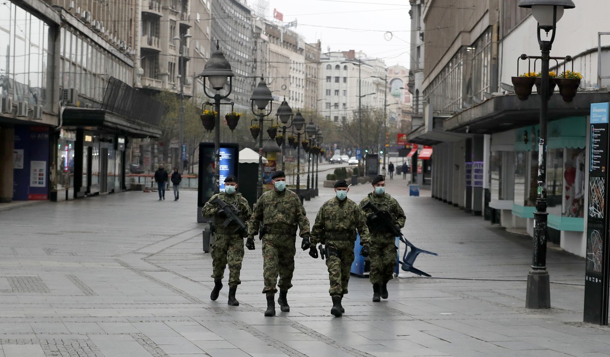 In this March 26, 2020, photo, Serbian army soldiers patrol in Belgrade's main pedestrian street, in Serbia. In the ex-communist Europe and elsewhere, rulers are assuming more power while they in ...