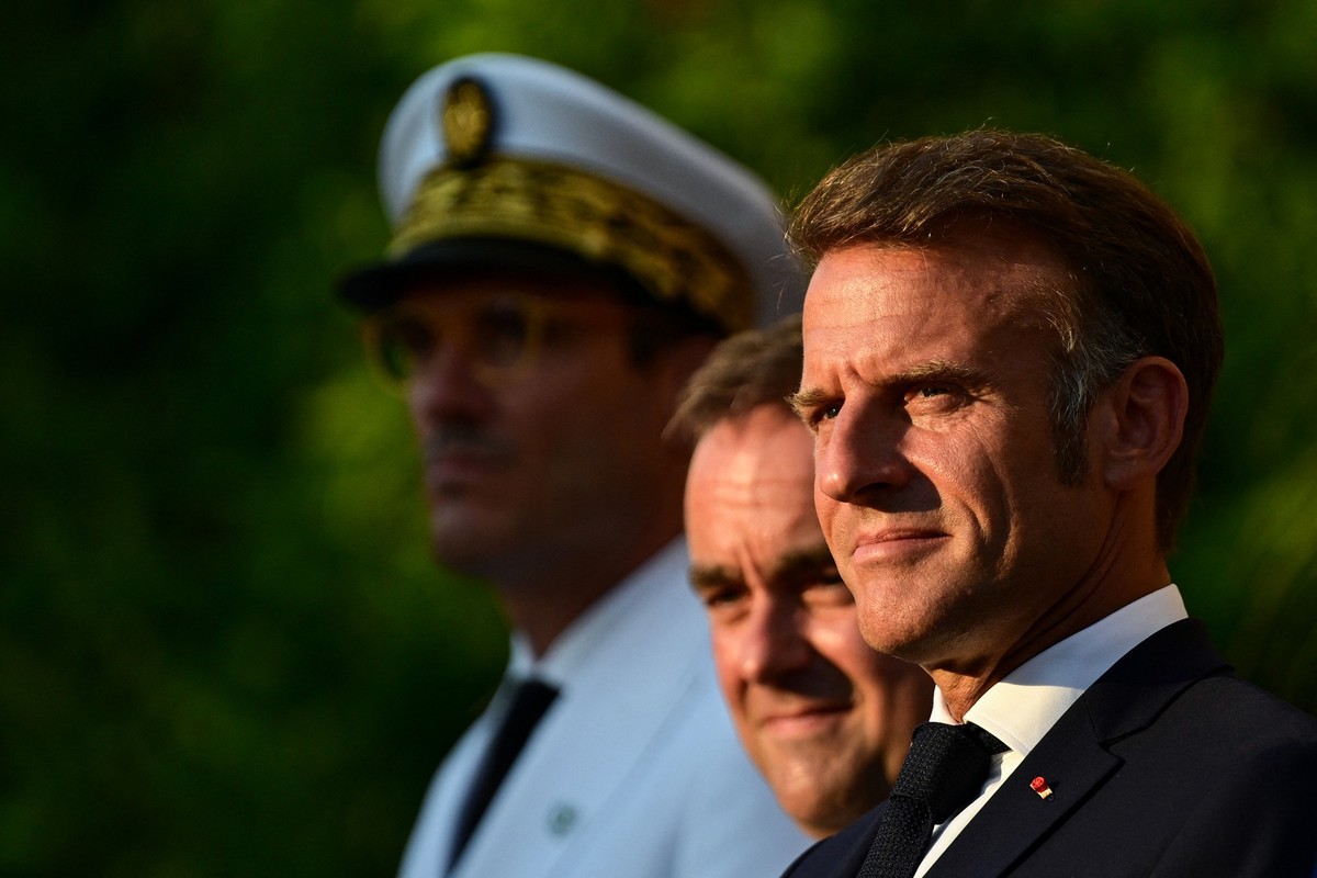 France's President Emmanuel Macron (R) and France's Minister of Armed Forces Sebastien Lecornu (C) look on during a ceremony marking the 81st anniversary of the liberation of Bormes-les-Mimo ...