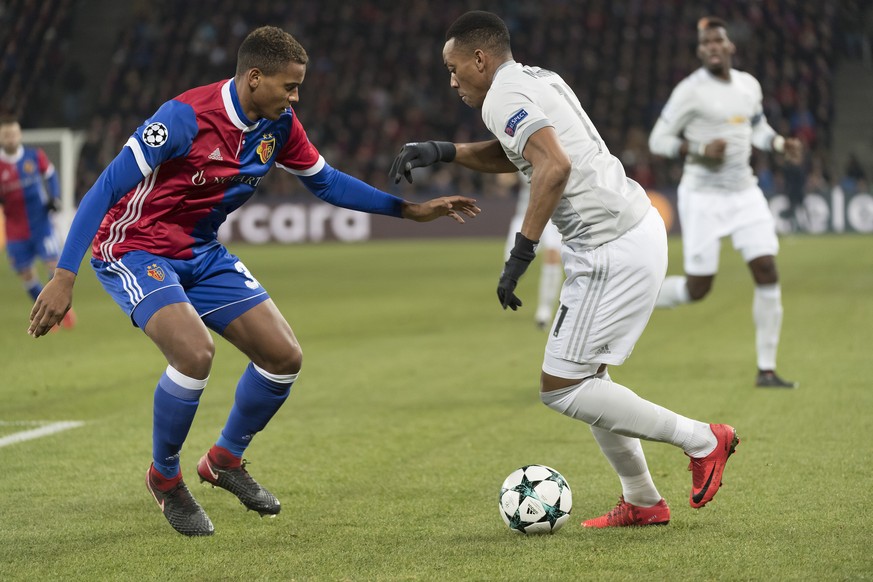 Basel's Manuel Akanji, left, fights for the ball against Manchester United's Anthony Martial, right, during the UEFA Champions League Group stage Group A matchday 5 soccer match between Swit ...