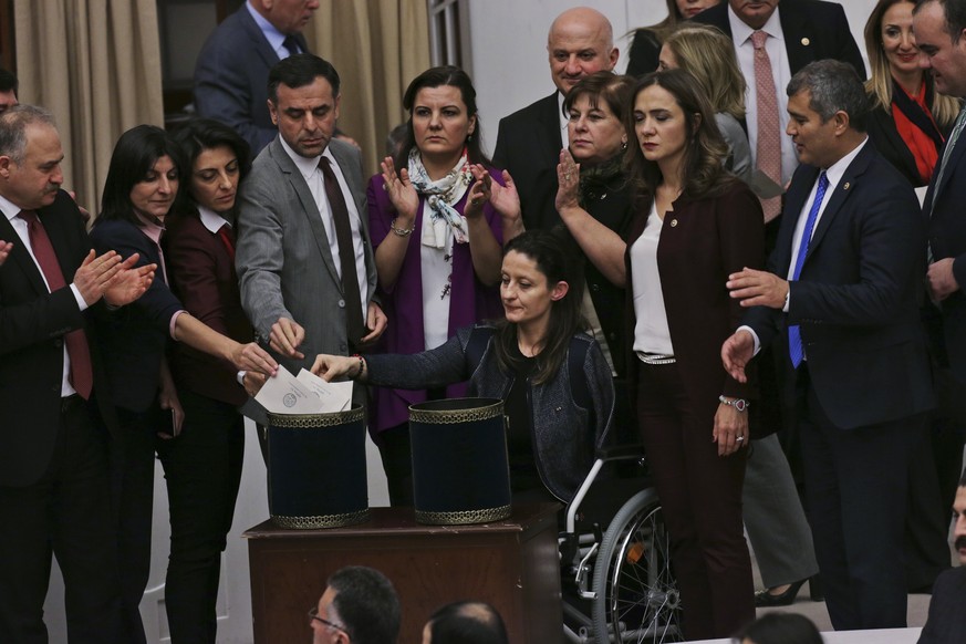 With some applauding, Turkey&#039;s main opposition Republican People&#039;s Party (CHP) legislators including Safak Pavey, centre, a lawmaker who uses a wheelchair, and was pushed to the ground durin ...