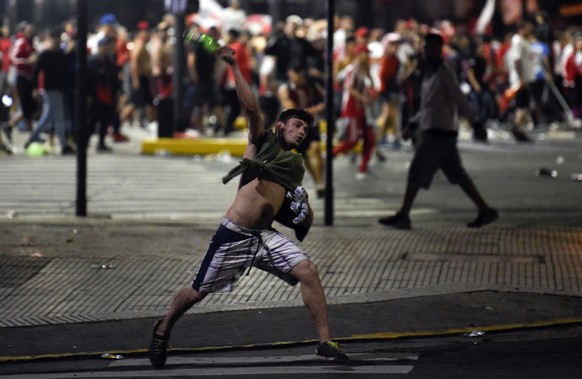 Fights break out between team fans as River Plate soccer fans celebrate their 3-1 victory over Boca Juniors, as River clinched the Copa Libertadores championship title, at the Obelisk in Buenos Aires, ...