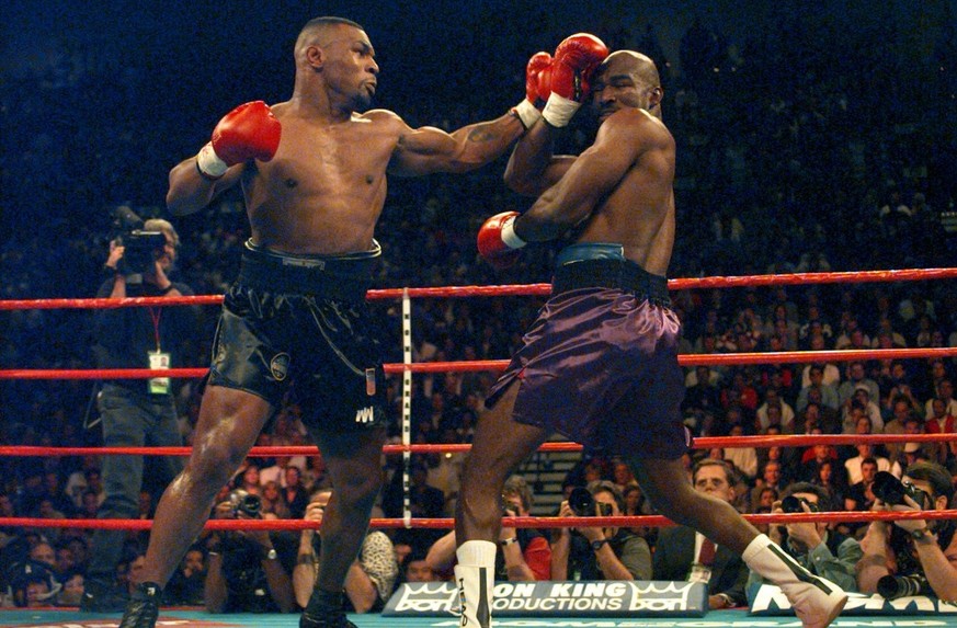 Mike Tyson and Evander Holyfield battle during their WBA Heavyweight Championship bout at the MGM Grand Garden in Las Vegas, Nev., Saturday, Nov. 9, 1996. (AP Photo/ Mark J. Terrill)
