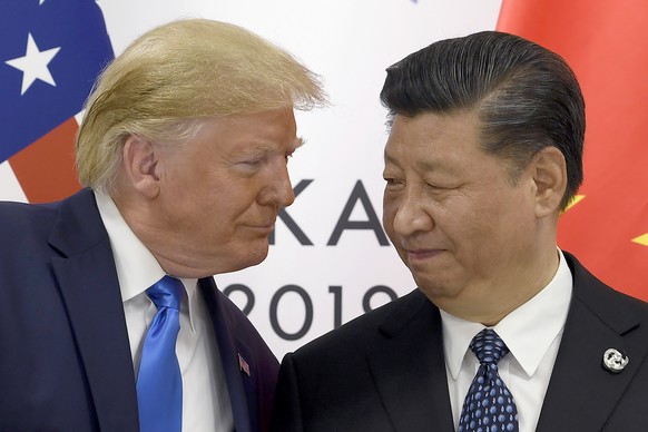 FILE - In this June 29, 2019, file photo, President Donald Trump, left, meets with Chinese President Xi Jinping during a meeting on the sidelines of the G-20 summit in Osaka, Japan. China has announce ...