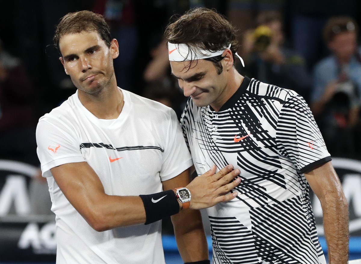 Switzerland's Roger Federer, right, is congratulated by Spain's Rafael Nadal, after Federer won the men's singles final at the Australian Open tennis championships in Melbourne, Austral ...