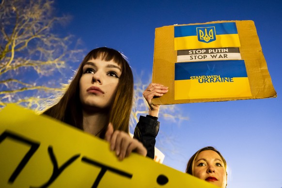 epaselect epa09799532 Protestors carry placards as they take part in a demonstration against the Russian invasion of Ukraine in Lausanne, Switzerland, 03 March 2022. Russian troops entered Ukraine on  ...