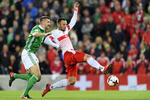 Northern Ireland&#039;s defender Gareth McAuley, left, fights for the ball with Switzerland&#039;s forward Haris Seferovic, right, during the 2018 Fifa World Cup play-offs first leg soccer match North ...