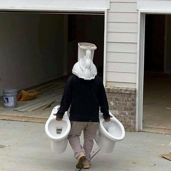 Failed Tuesday: Man carries toilet bowl on his head.
