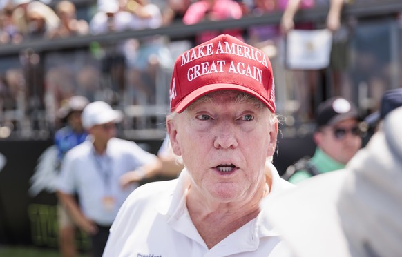 epa10795751 Former US President Donald J. Trump on the first tee at the start of the first round of the LIV Golf tournament at Trump National Golf Club Bedminster in Bedminster, New Jersey, USA, 11 Au ...