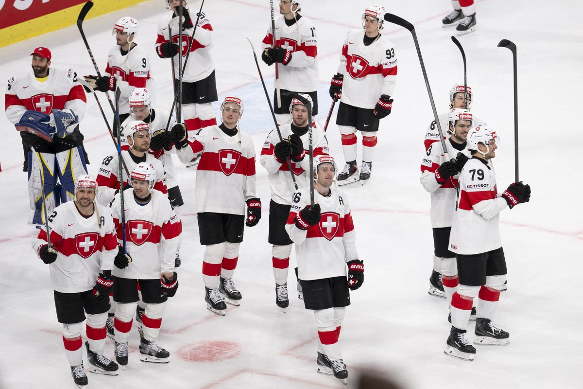 Switzerland's players celebrates after the win in the 2026 IIHF Men's Ice Hockey World Championship preliminary round group A game between Germany and Switzerland, at the Swiss Life Arena ic ...