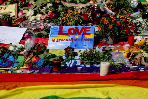 epa13135318 Tributes left at a mourning site in front of the Brandenburg Gate, near the scene where a vehicle plowed into a crowd on the sideline of the Christopher Street Day (CSD) parade in Berlin,  ...
