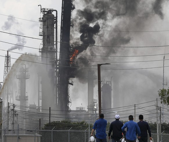 Flames and smoke rise after a fire started at an Exxon Mobil facility, Wednesday, July 31, 2019, in Baytown, Texas (Jon Shapley/Houston Chronicle via AP)