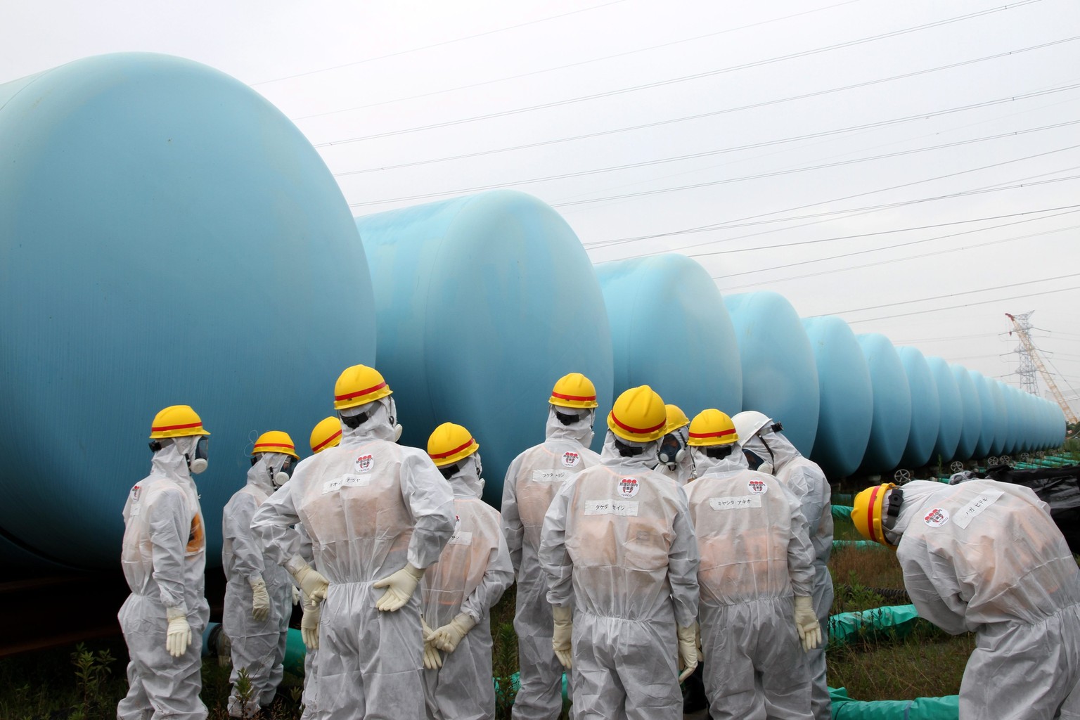 epa03848740 (FILE) A file handout picture taken on 23 August 2013 and provided by the Japan Nuclear Regulation Authority shows Japan Nuclear Regulation Authority (NRA) members wearing protective suits ...