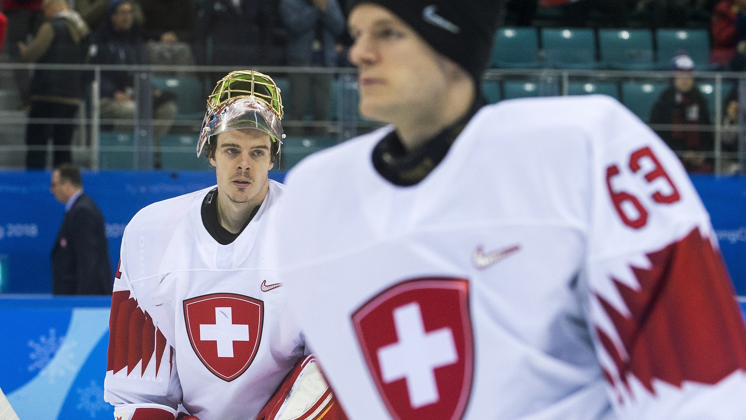 Jonas Hiller, goalkeeper of Switzerland, and Leonardo Genoni, goalkeeper of Switzerland, from left, after the men ice hockey preliminary round match between Switzerland and Czech Republic in the Gangn ...