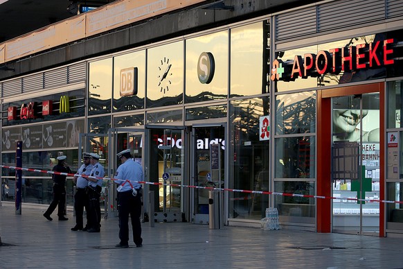 16.10.2018, Nordrhein-Westfalen, Koeln: Polizisten stehen vor einem Schnellrestaurant und einer Apotheke im Hauptbahnhof. Nach der Geiselnahme in einer Apotheke im Koelner Hauptbahnhof prueft die Poli ...