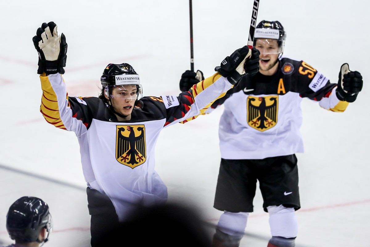 epa07570749 Moritz Seider of Germany (L) celebrates scoring with teammate Patrick Hager (R) during the IIHF World Championship group A ice hockey match between Germany and France at the Steel Arena in ...