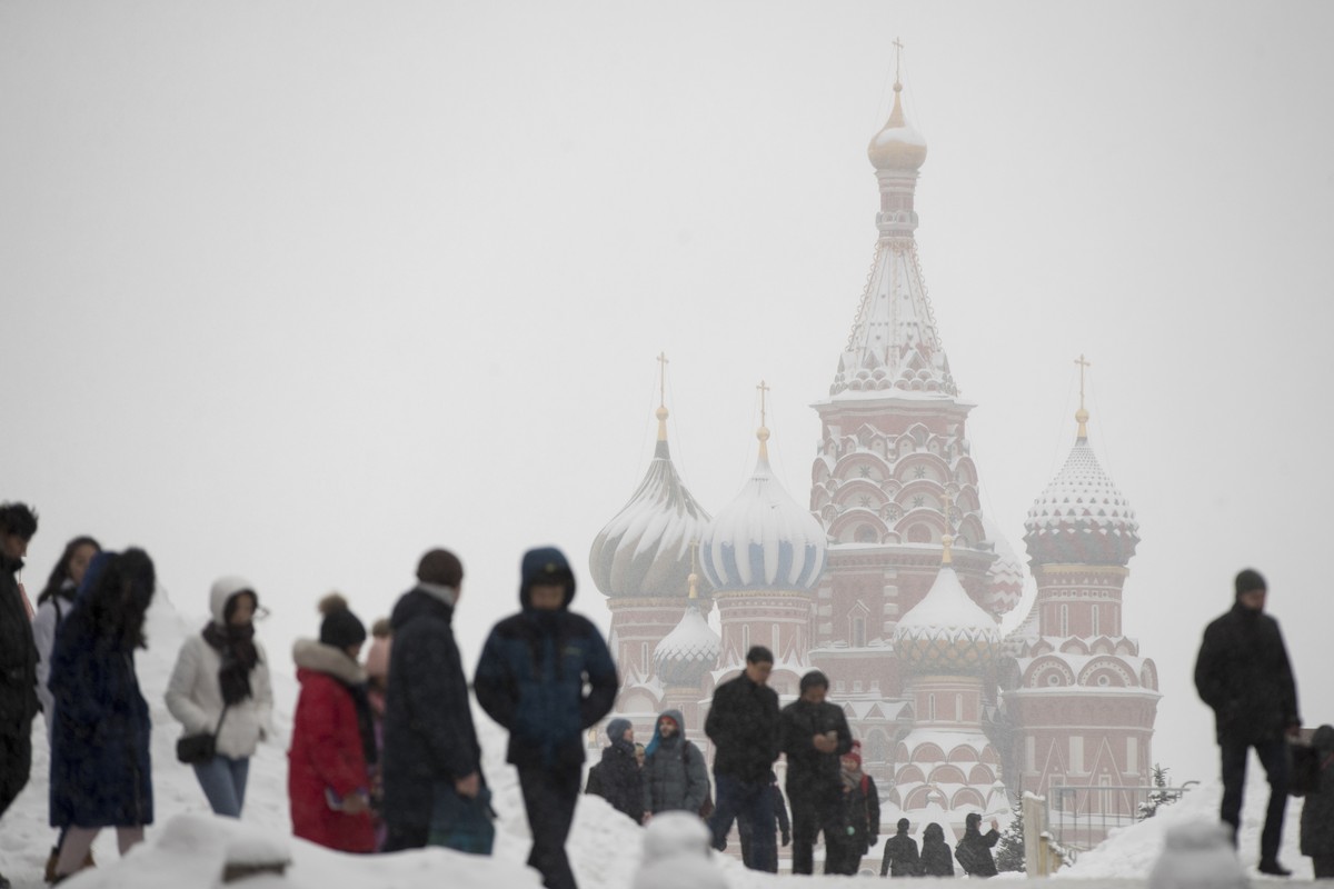 People walk in snow in Moscow's Red Square, with the St. Basil's Cathedral in the background Russia, Wednesday, Jan. 31, 2018. According to forecasts snowfalls and blizzard will continue in  ...
