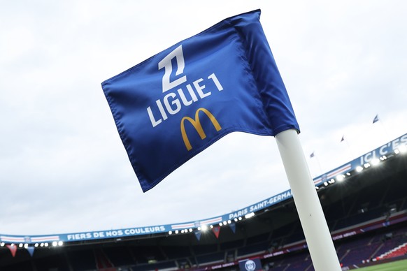 epa11561877 A flag featuring the logo of the McDonald&#039;s restaurant chain, sponsor of Ligue 1 for the next three seasons, flies before the kick off of the Ligue 1 soccer match between Paris Saint  ...