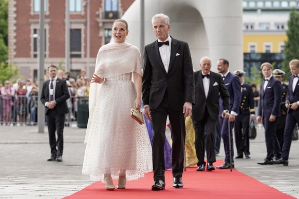 epa10016598 Norway&#039;s Princess Ingrid Alexandra (L), accompanied by Norway&#039;s Prime Minister Jonas Gahr Stoere, arrives at the government&#039;s party event in connection with her 18th birthda ...