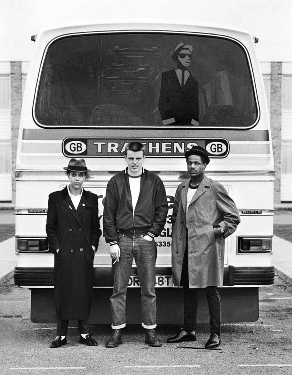 Pauline Black of The Selecter, Suggs of Madness and Neville Staple of The Specials pose behind the tour bus at the first date of the 2 Tone Tour in Brighton, United Kingdom in October 1979. The 2 Tone ...