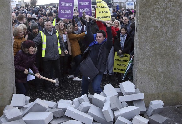 Demonstrators knock down a &#039;mock&#039; wall on the Northern Ireland/Republic of Ireland border, near Newry in Northern Ireland, Saturday, Jan. 26, 2019. Protesters angered at the prospect of a ha ...