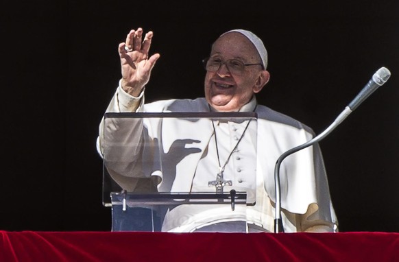 epa11034023 Pope Francis waves to the crowd from the window of the Apostolic Palace overlooking St. Peter's Square during the weekly Angelus prayer, Vatican City, December 17, 2023. Pope Francis...