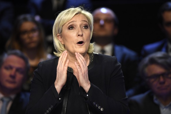 epa05888727 French presidential election candidate for the far-right National Front (FN) party Marine Le Pen gestures as she speaks during a debate organized by French private TV channels BFM TV and C ...