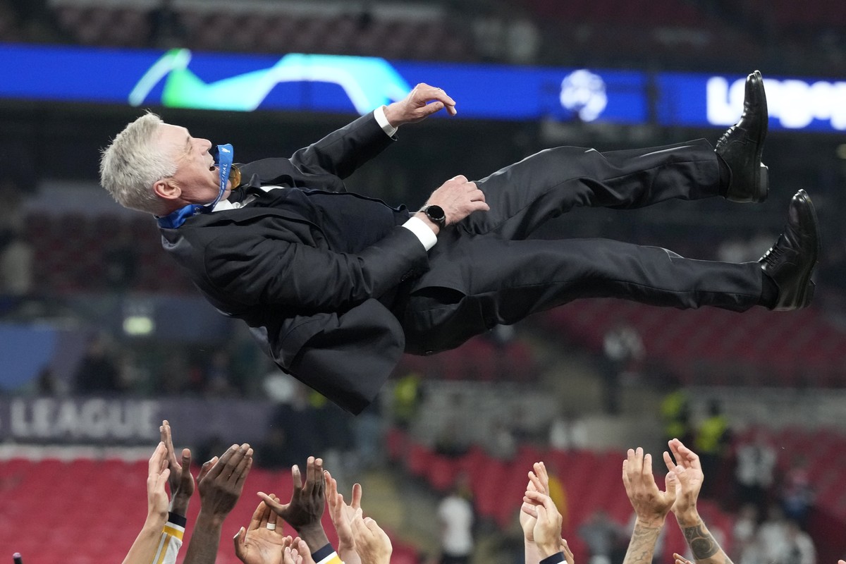 Real Madrid's players throw head coach Carlo Ancelotti in the air after winning the Champions League final soccer match between Borussia Dortmund and Real Madrid at Wembley stadium in London, Sun ...