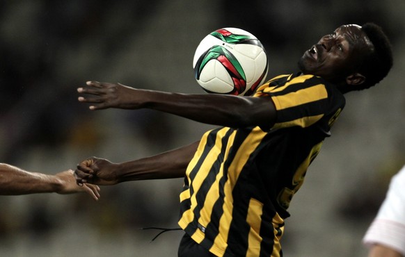 epa04877638 Mackolley Chrisantus (R) of AEK Athens in action against Coke (L) of Sevilla FC during their pre season friendly soccer match between AEK Athens and Svillla FC held at OAKA stadioum in Ath ...