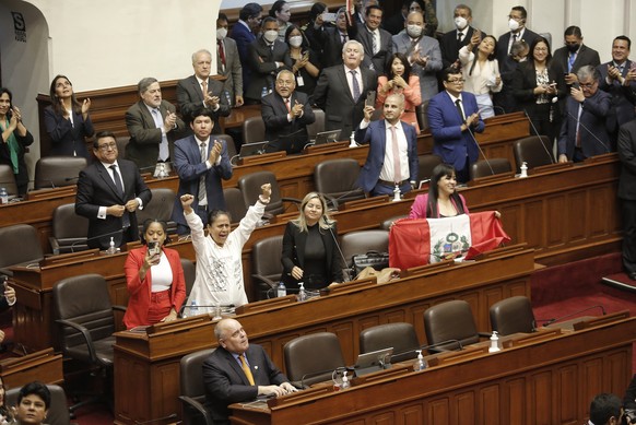 epa10353954 Deputies celebrate with a photograph the decision of Congress to remove the president of Peru, Pedro Castillo, in Lima, Peru, 07 December 2022. The plenary session of the Peruvian Congress ...