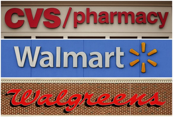 FILE - This undated combination of file photos show the signs of CVS, Walmart and Walgreens. A federal judge in Cleveland awarded $650 million in in damages on Wednesday, Aug. 17, 2022, to two Ohio co ...