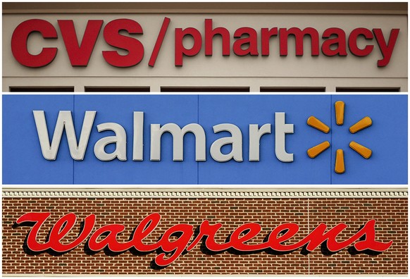 FILE - This undated combination of file photos show the signs of CVS, Walmart and Walgreens. A federal judge in Cleveland awarded $650 million in in damages on Wednesday, Aug. 17, 2022, to two Ohio co ...