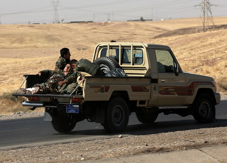 An Kurdish security forces fighter is rushed to the hospital after being injured in clashes against Federal Iraqi security forces in Alton Kupri town, outskirts of Irbil, Iraq, Friday Oct. 20, 2017. I ...