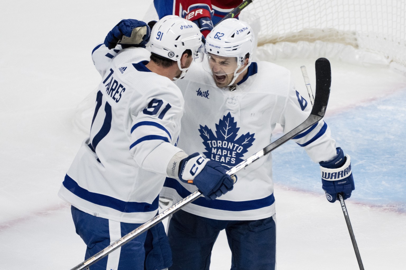 Toronto Maple Leafs' Denis Malgin, right, celebrates his goal against the Montreal Canadiens with John Tavares during the second period of an NHL hockey game Wednesday, Oct. 12, 2022, in Montreal. (Pa ...