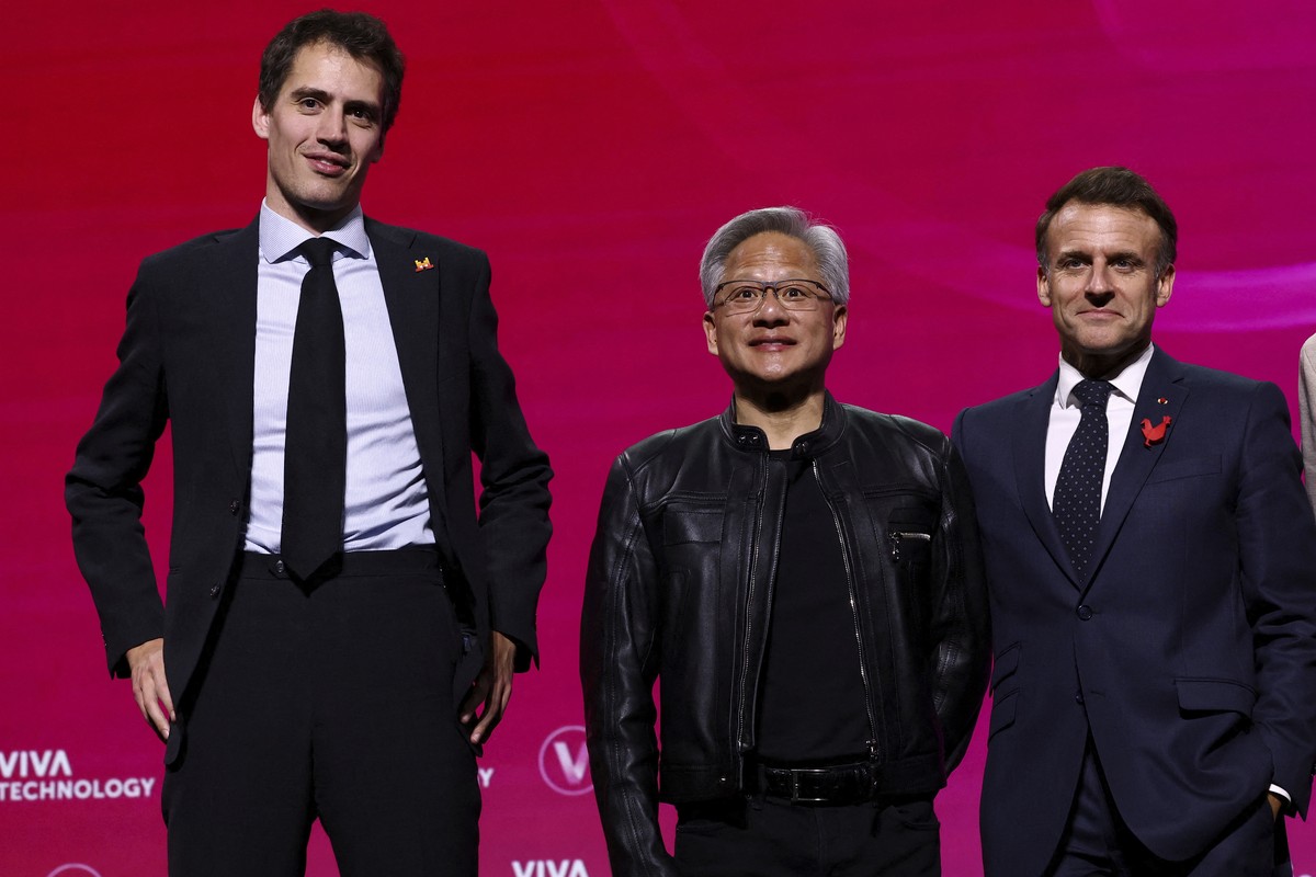 Mistral CEO Arthur Mensch, left, Nvidia CEO Jensen Huang, center, and French President Emmanuel Macron attend a round table discussion at the VivaTech fair dedicated to innovation and startups in Pari ...