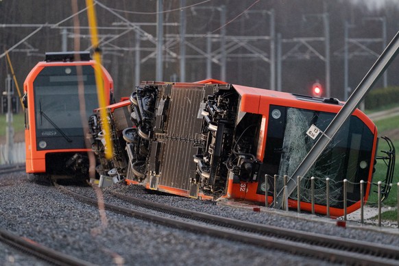 epa10552778 A general view of the site of a derailed train of the company Aare Seeland mobil, in Luescherz, Switzerland, 31 March 2023. EPA/Manuel Lopez