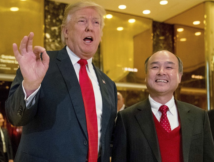 FILE - In this Tuesday, Dec. 6, 2016, file photo, President-elect Donald Trump, left, accompanied by SoftBank CEO Masayoshi Son, speaks to members of the media at Trump Tower in New York. Trump gave h ...